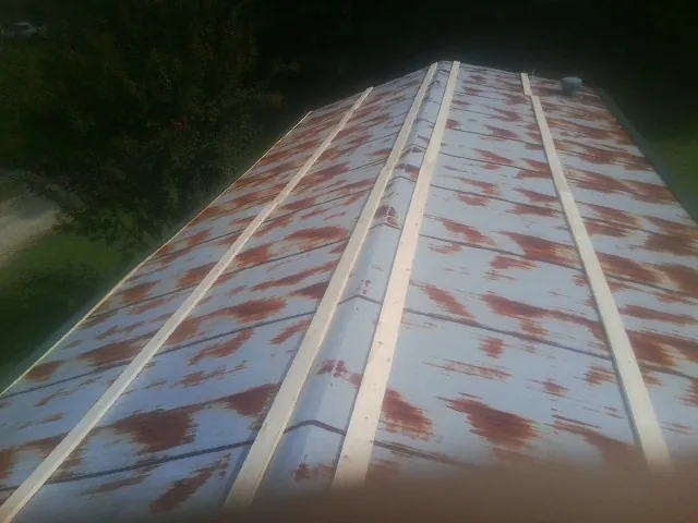 Rusted metal roof panels with new wood purlins before replacement — Storm Damage Roof Repair in Tipp City by Roofing Brothers