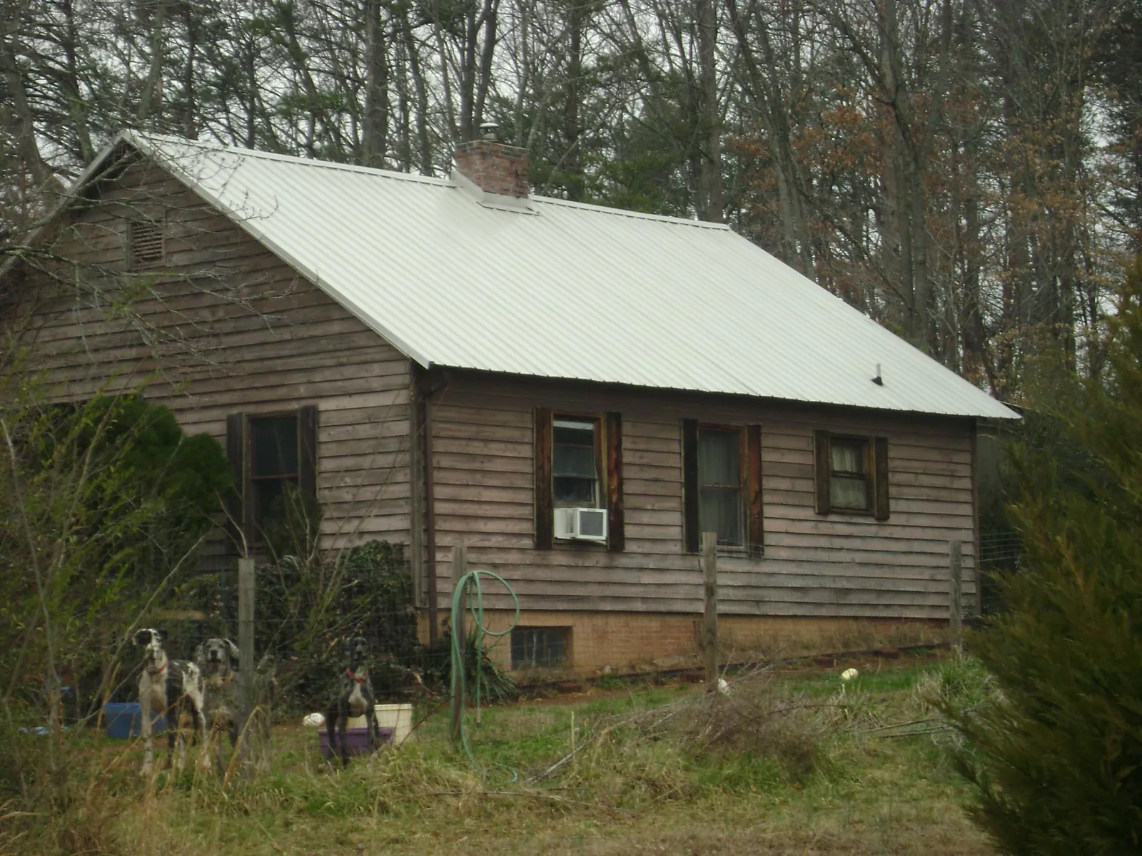 White metal roof on an old wood sided farmhouse, from a Metal Roof Installation job in Tipp City